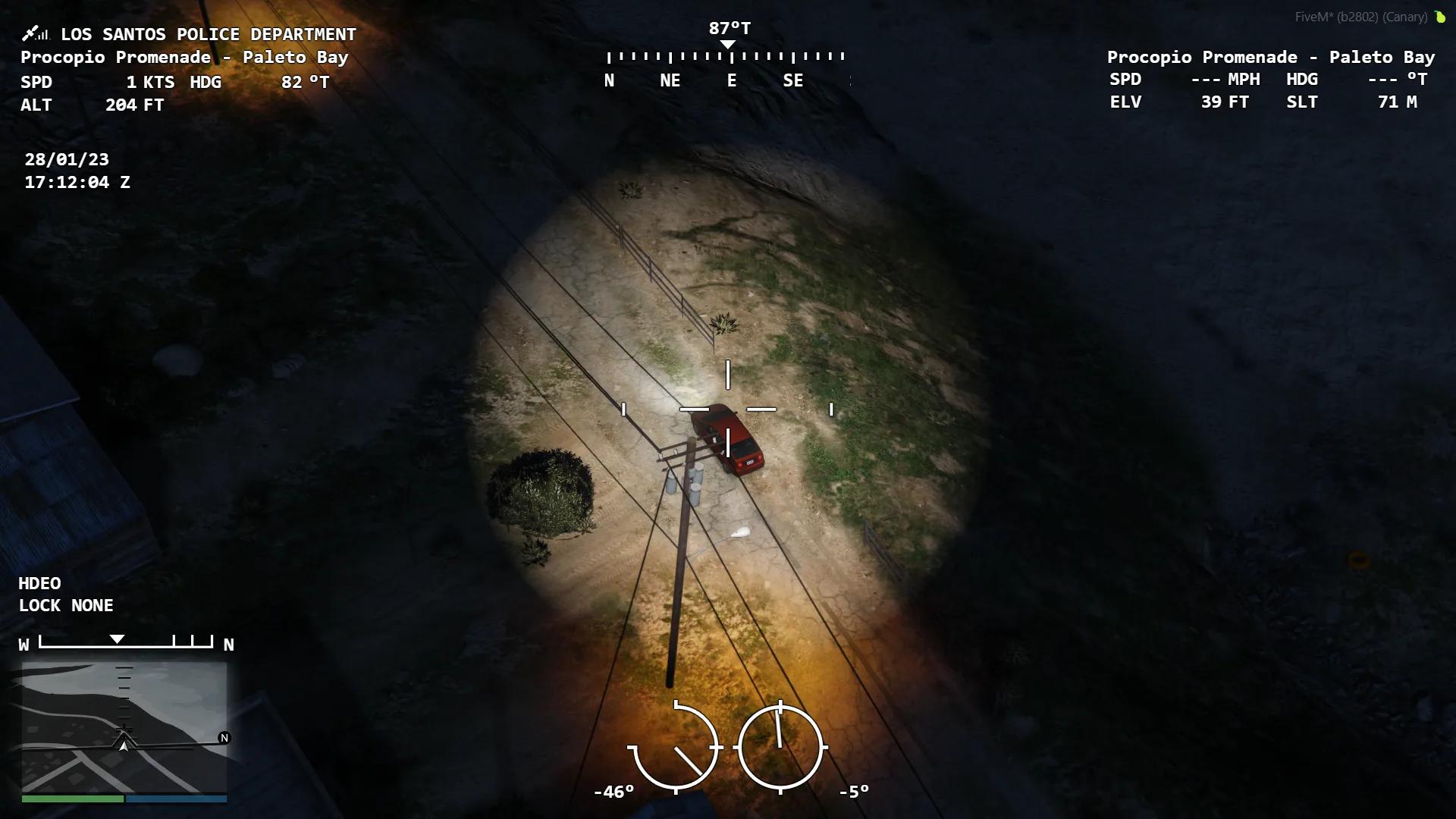 FiveM police helicopter camera illuminating suspects on the ground with an aerial spotlight at night.