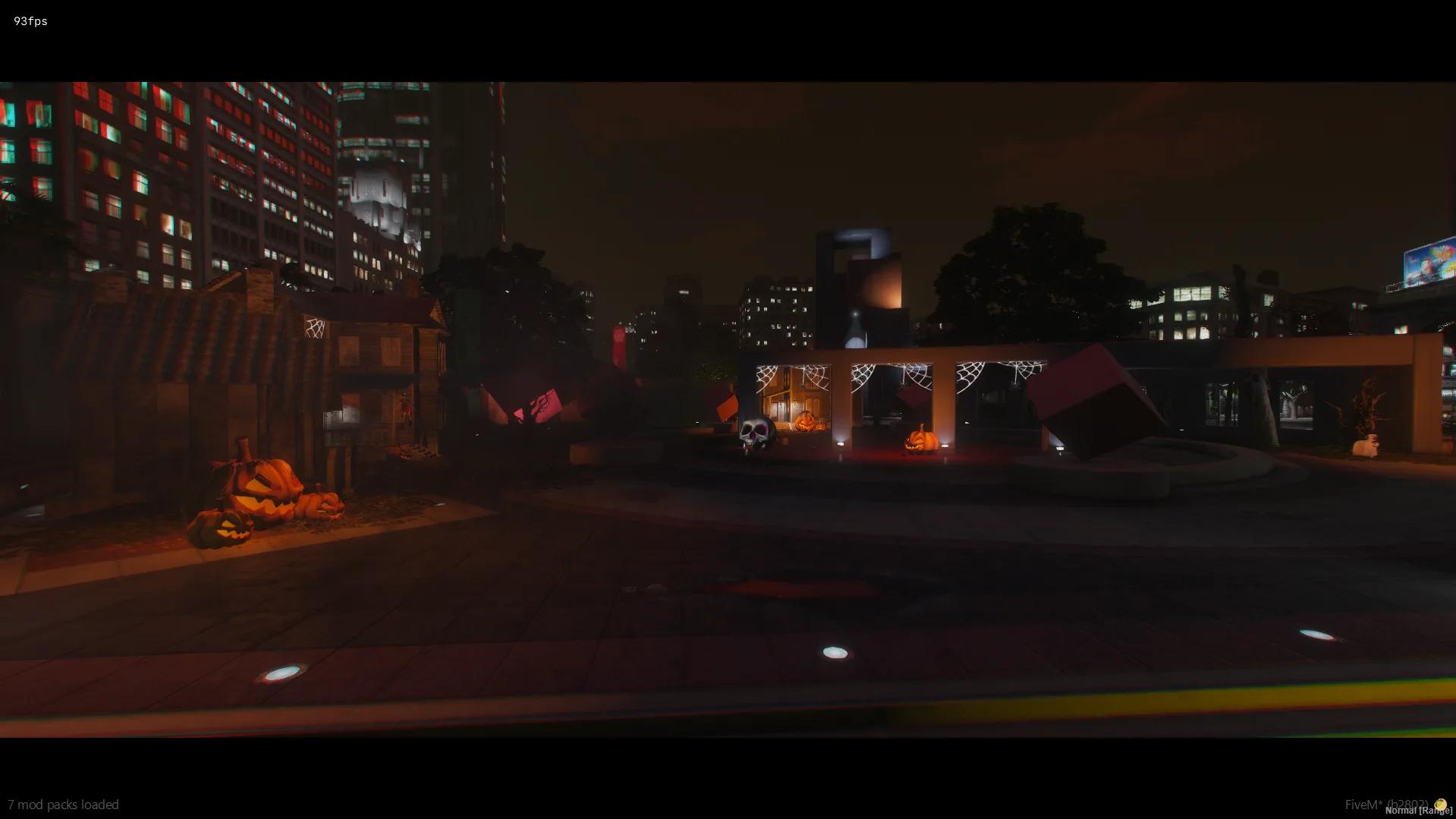Legion Square plaza with cobwebs, a skull and pumpkins after dark