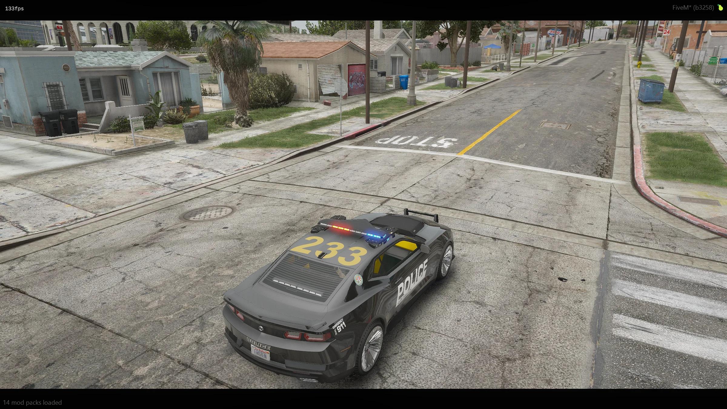 Police car with a yellow roof callsign 233 at a stop line
